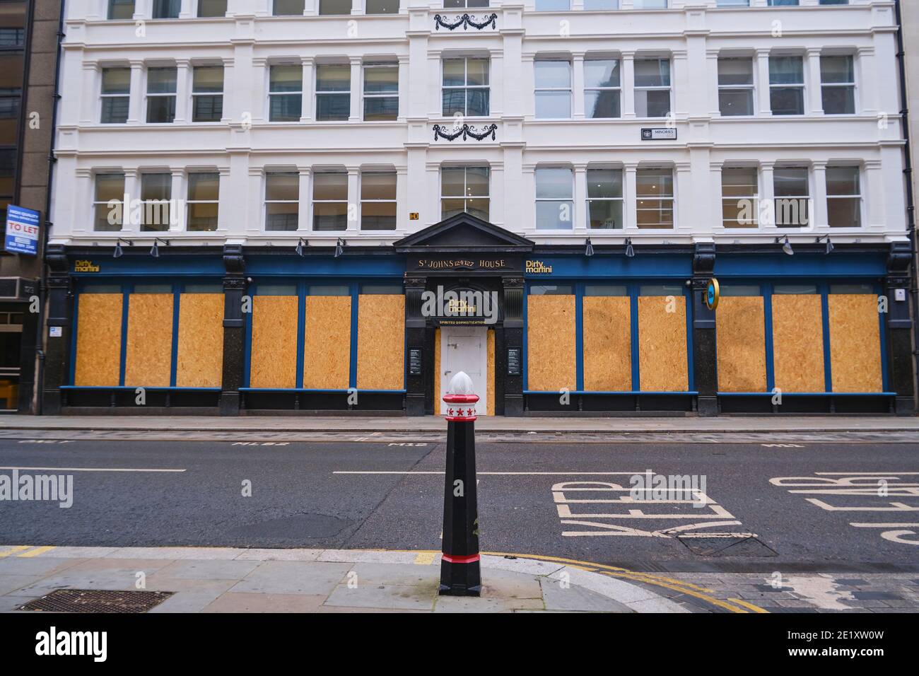 A closed and boarded Dirty Martini Bar in the City of London during the Coronavirus Lockdown, The Minories, London, United Kingdom, 10th Jaunuary 2021 Stock Photo