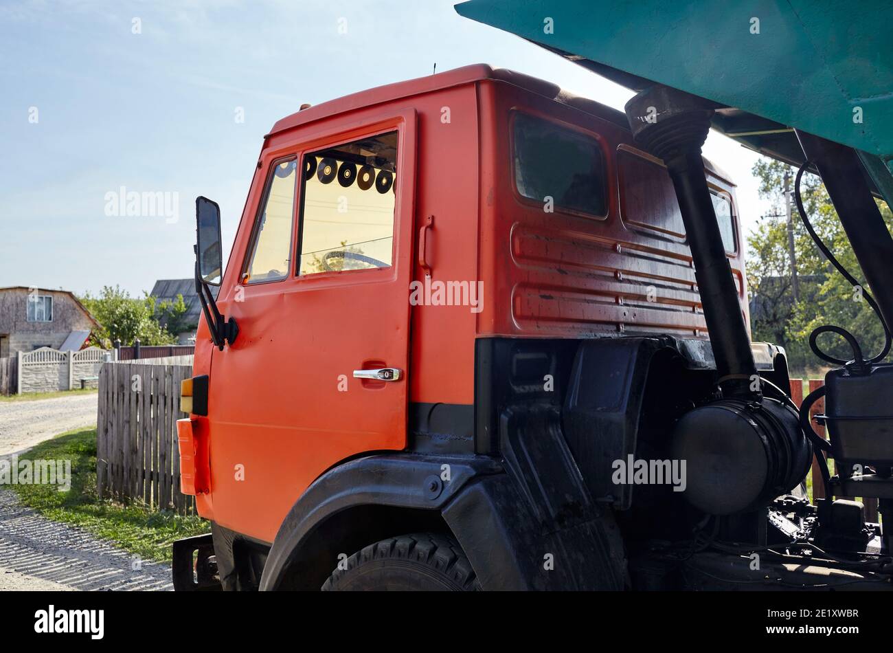 Big dump truck on suburban street, truck cab. Waiting for dumping gravel for building and reconstruction roadway Stock Photo