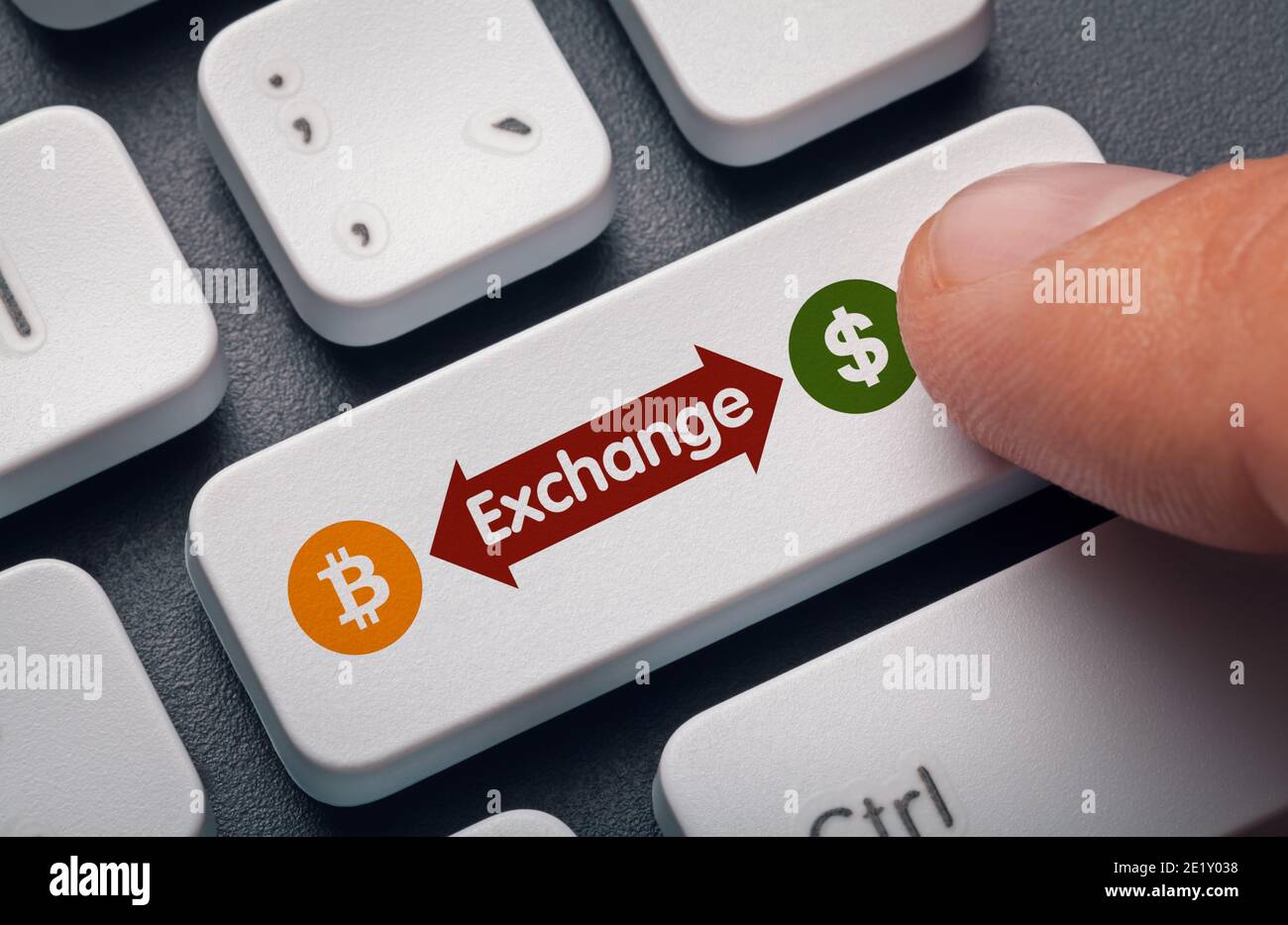 finger pressing computer key with bitcoin, dollar symbol and exchange word. crypto mining concept. Stock Photo