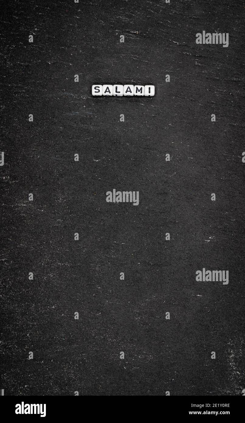 Word salami on black stone background Stock Photo