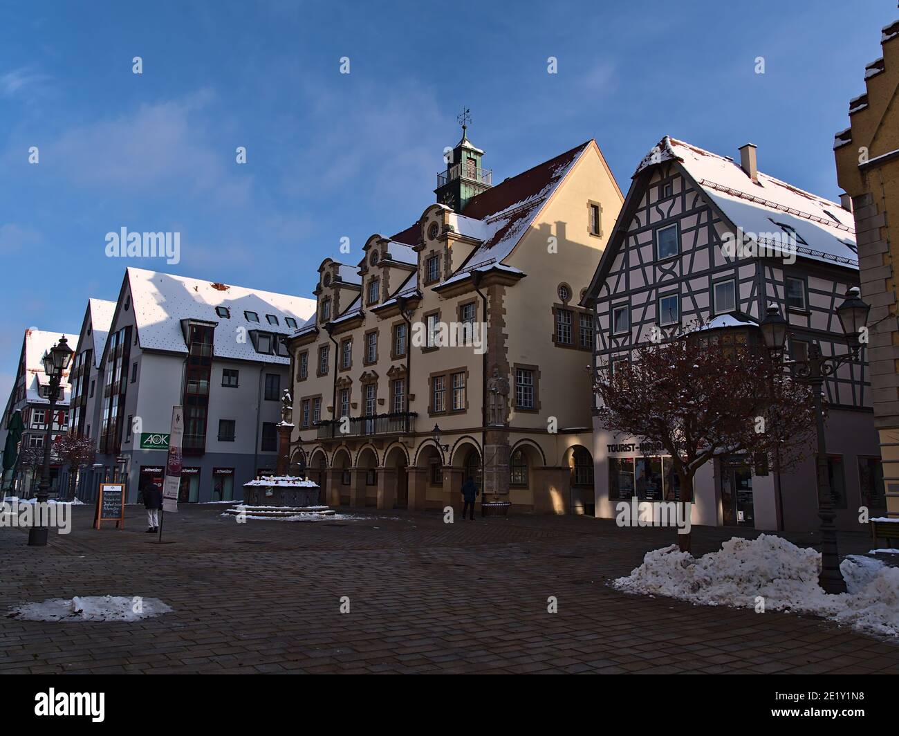 Sigmaringen, Germany - 01-09-2021: Historic town hall with yellow painted facade located at a square in pedestrian zone in city center. Stock Photo