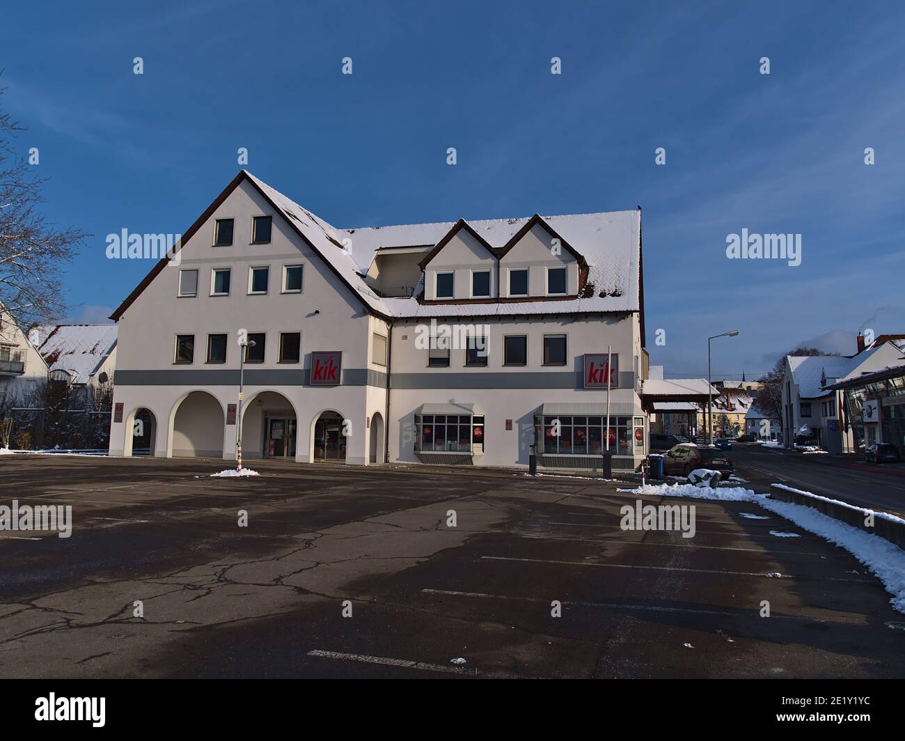 Sigmaringen, Germany - 01-09-2021: Clothing store of German retail textile discount shopping chain KiK with red company logo and parking lot. Stock Photo