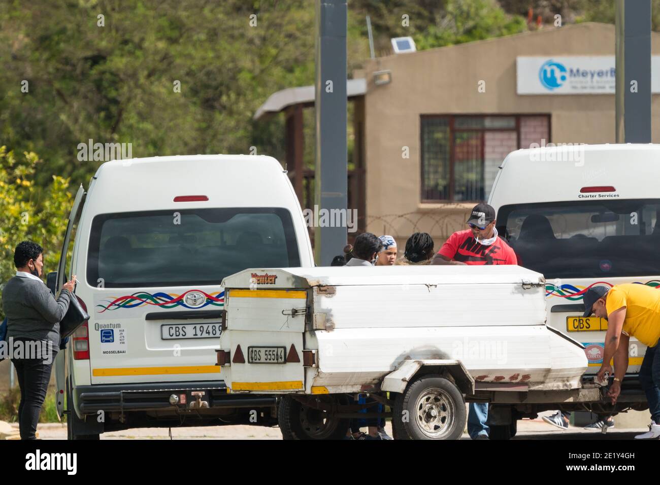 South African taxi service at a taxi rank in the Western Cape of South Africa showing people or commuters waiting to board their vehicles Stock Photo