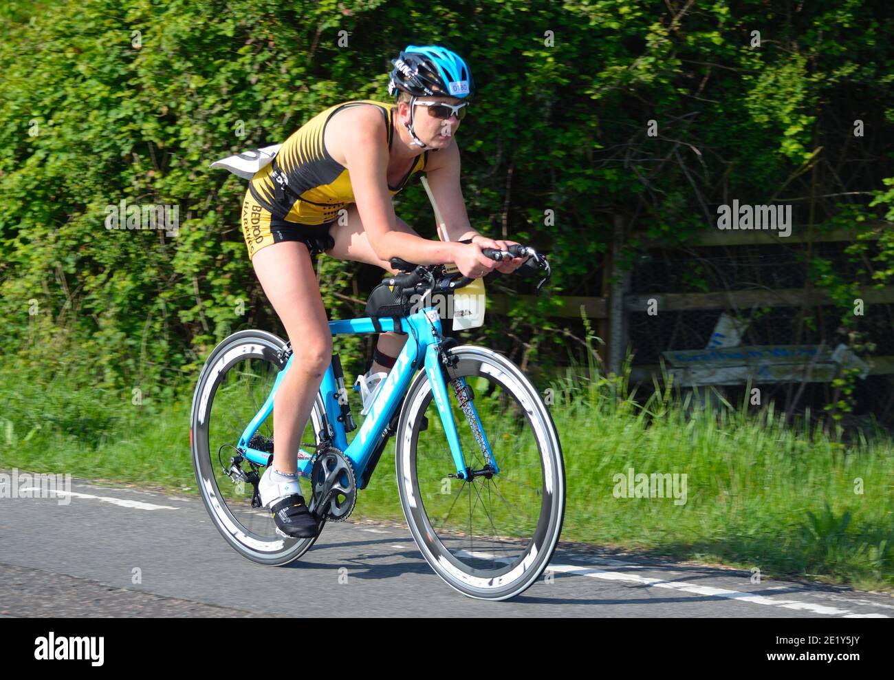 Close up of Female triathlete on road cycling stage. Stock Photo