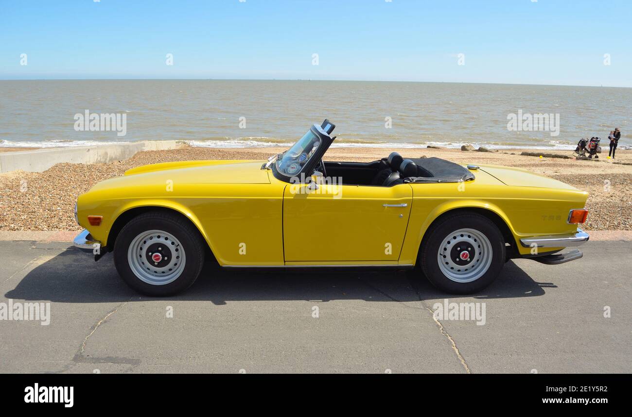 Classic Yellow Triumph TR6 on the seafront at Felixstowe. Stock Photo