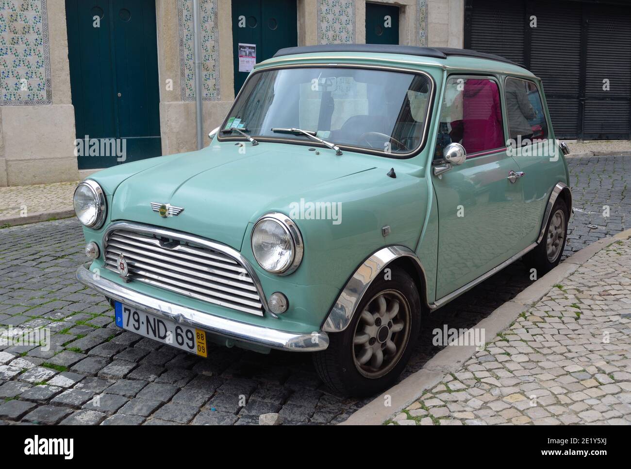 Classic light blue Austin Mini motorcar in the streets of the Alfama district of Lisbon Portugal. Stock Photo