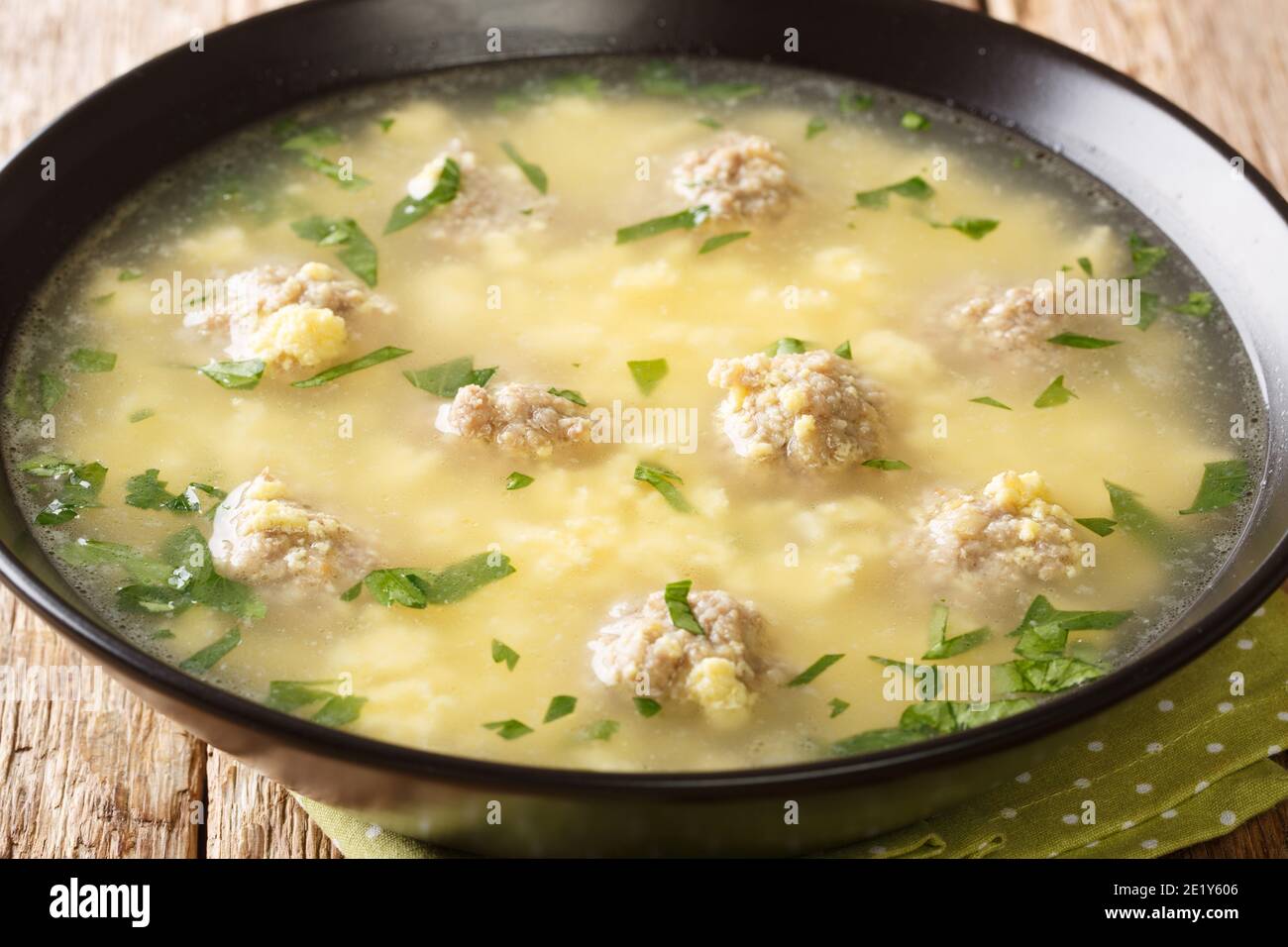 Sciusceddu or Italian Meatball and Egg Soup, is a popular, beef broth based soup served traditionally during Easter celebrations closeup in the plate Stock Photo