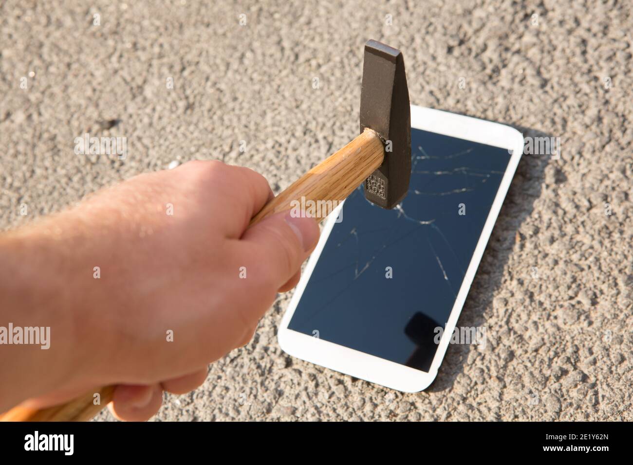 hammer smashing the screen of a smartphone Stock Photo Alamy
