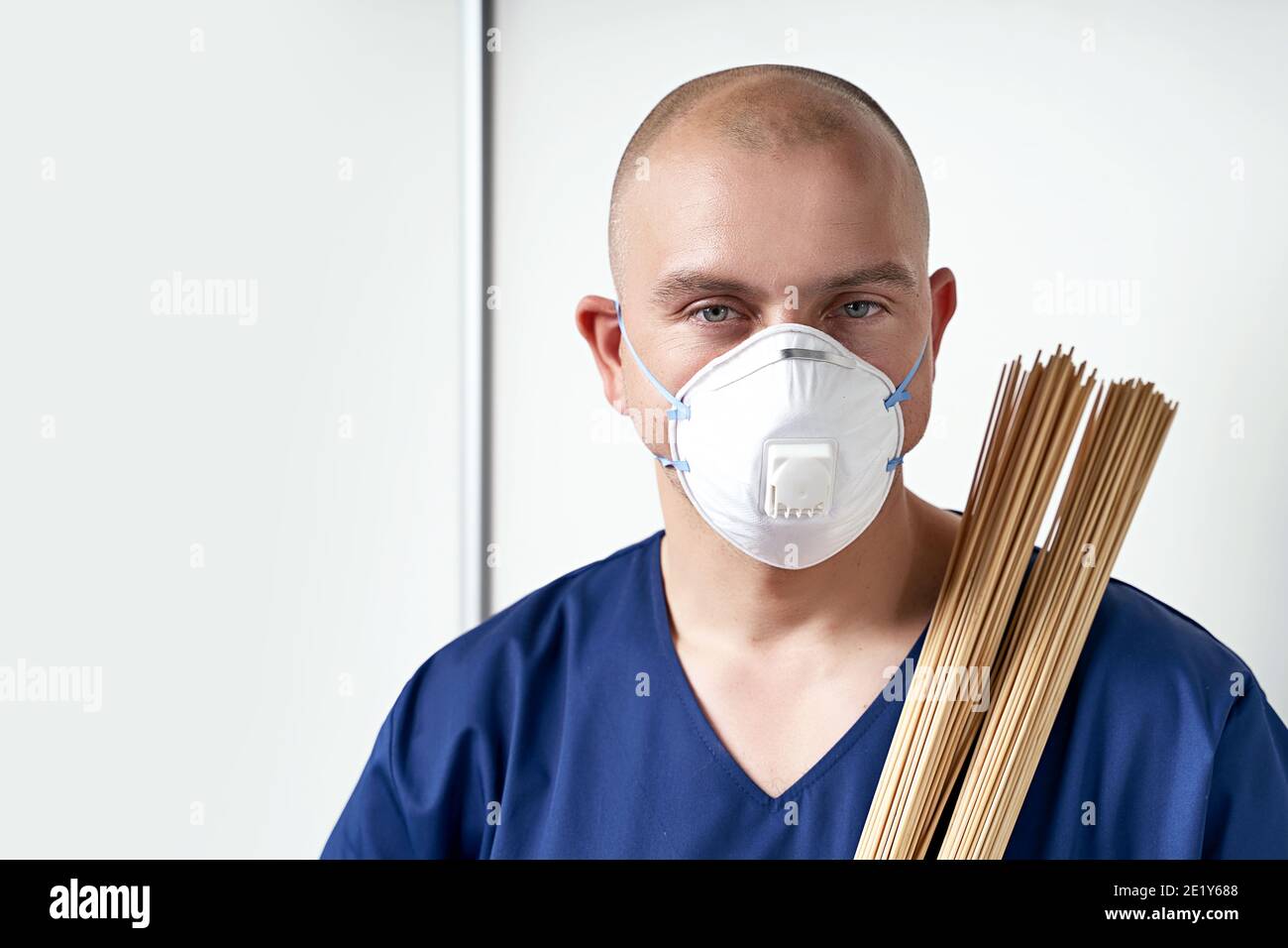 Experienced male massage therapist masseur in his medical office