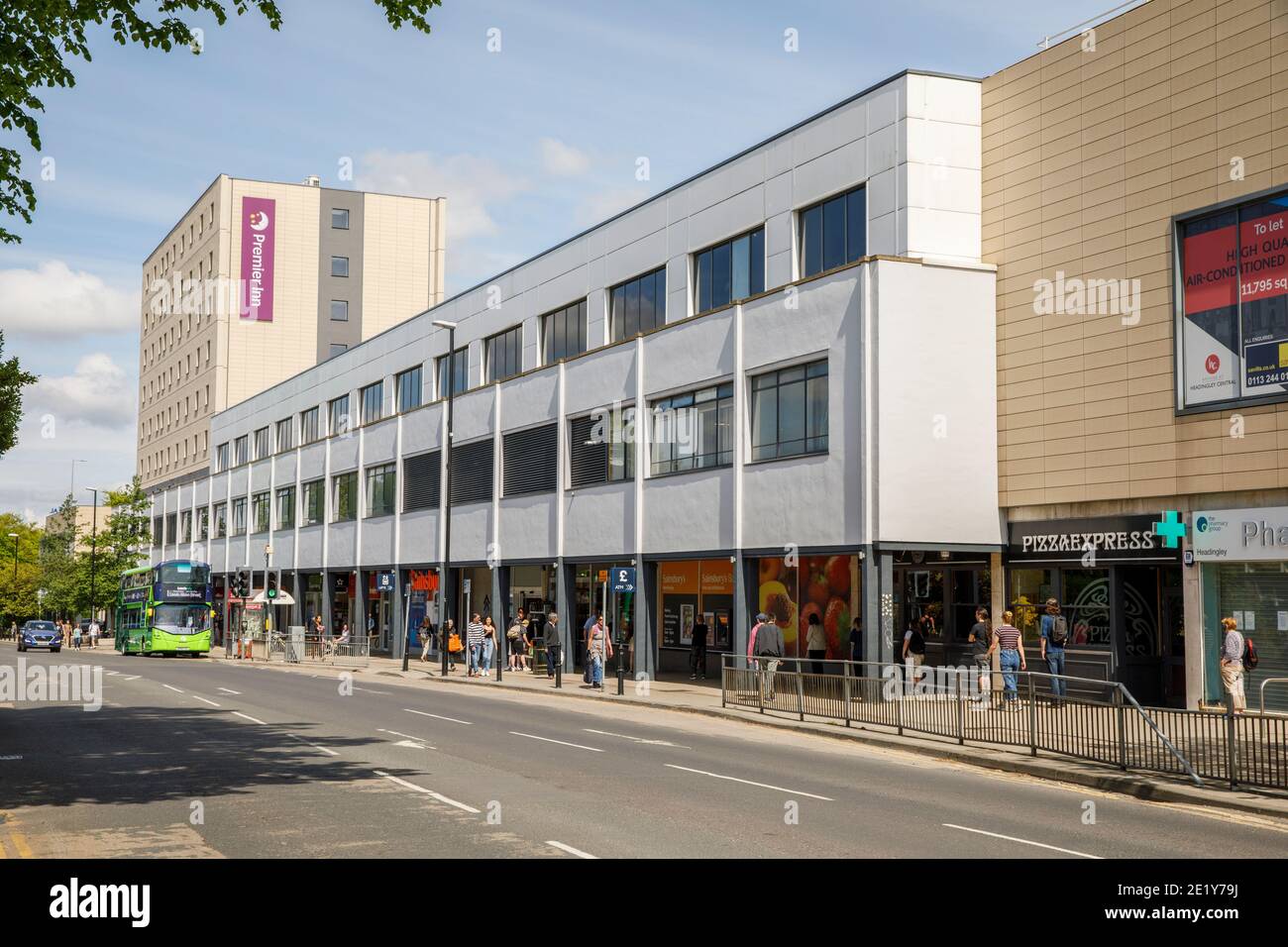 The Arndale Centre on Otley Road, Headingley, Leeds with shoppers and bus in the street and Premier Inn in background Stock Photo