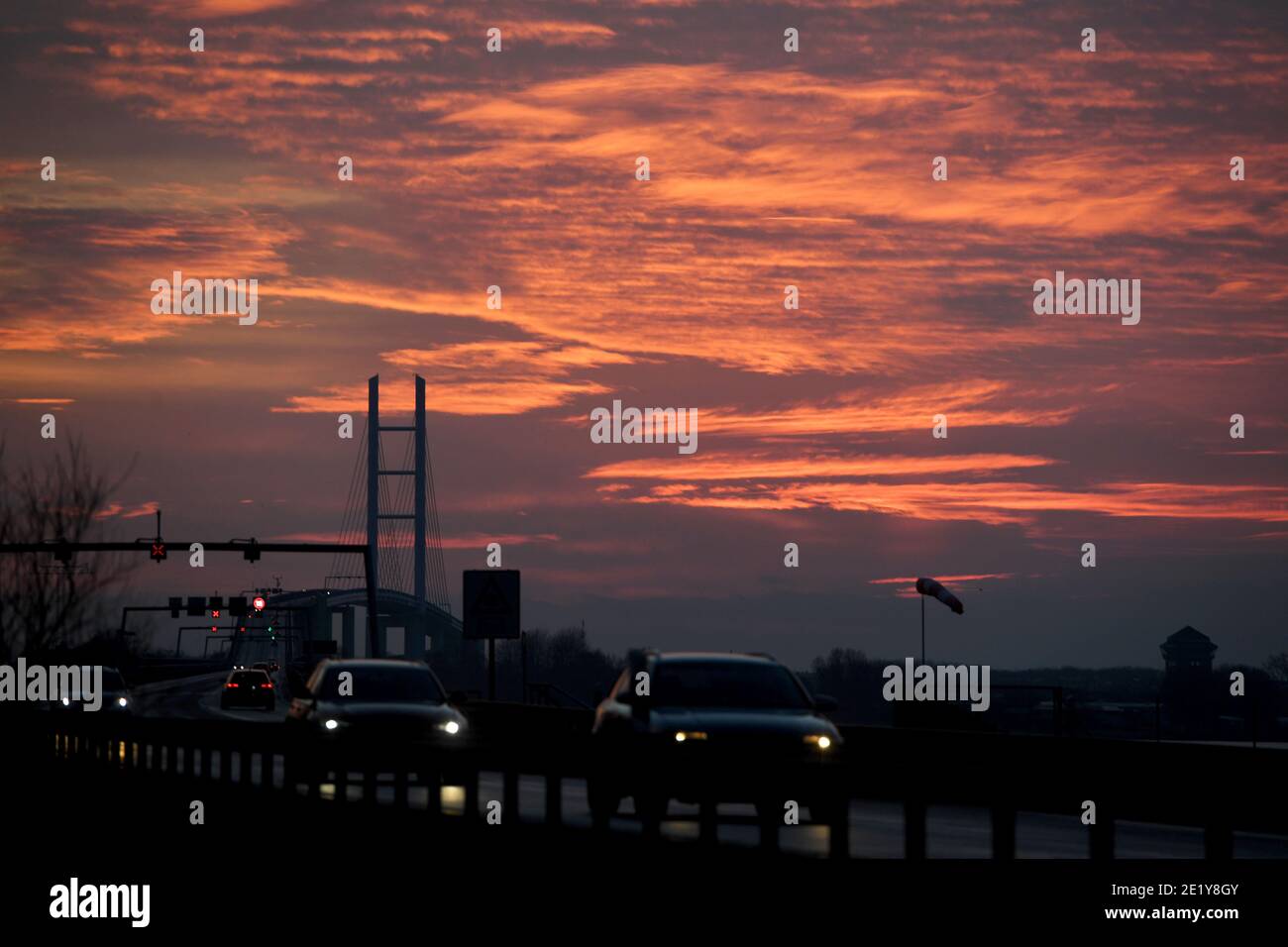 10 January 2021, Mecklenburg-Western Pomerania, Altefähr: The sky above the silhouette of the Rügenbrücke B96, taken from the island of Rügen, is colourful at sunset. Photo: Stefan Sauer/dpa-Zentralbild/ZB Stock Photo
