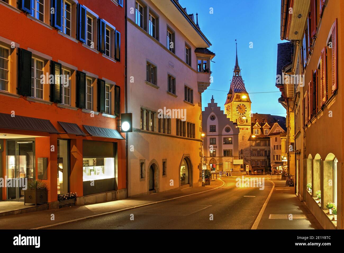 Night scene in Zug with a road leading to Kolinplatz and the Zytturm Tower. Stock Photo
