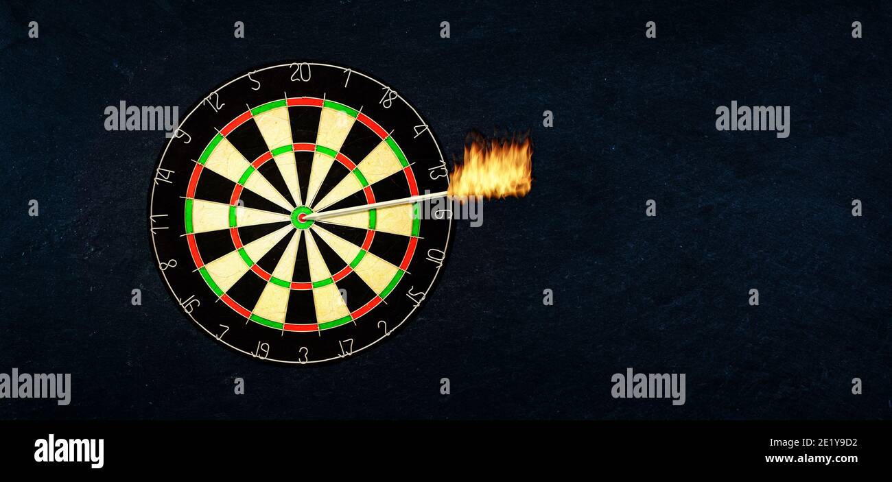 Success and business concept: Dartboard with burning arrow in the bulls eye or the target. Stock Photo