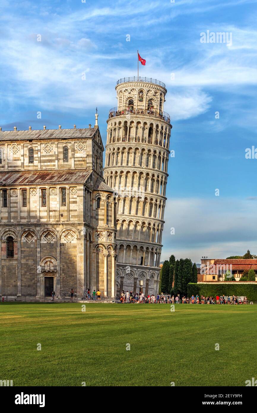Vertical composition with the Leaning Tower by the straight Duomo in Campo dei Miracoli, Pisa, Tuscany, Italy. The leaning tower is one of the most re Stock Photo