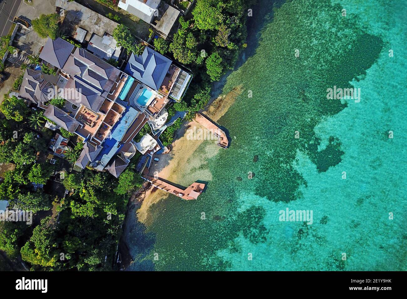 Aerial of Moxon Beach Club on the northern shores of Jamaica in Boscobel Ocho Rios, St. Mary parish. The bohemian hotel has a little private beach fla Stock Photo