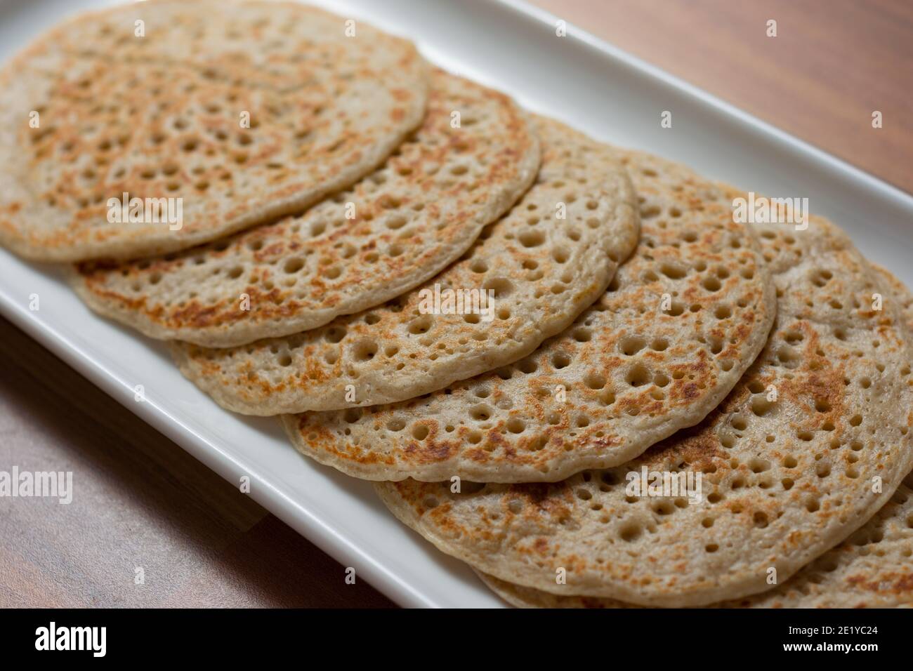 Derbyshire oatcakes viewed from the side on a white platter Stock Photo