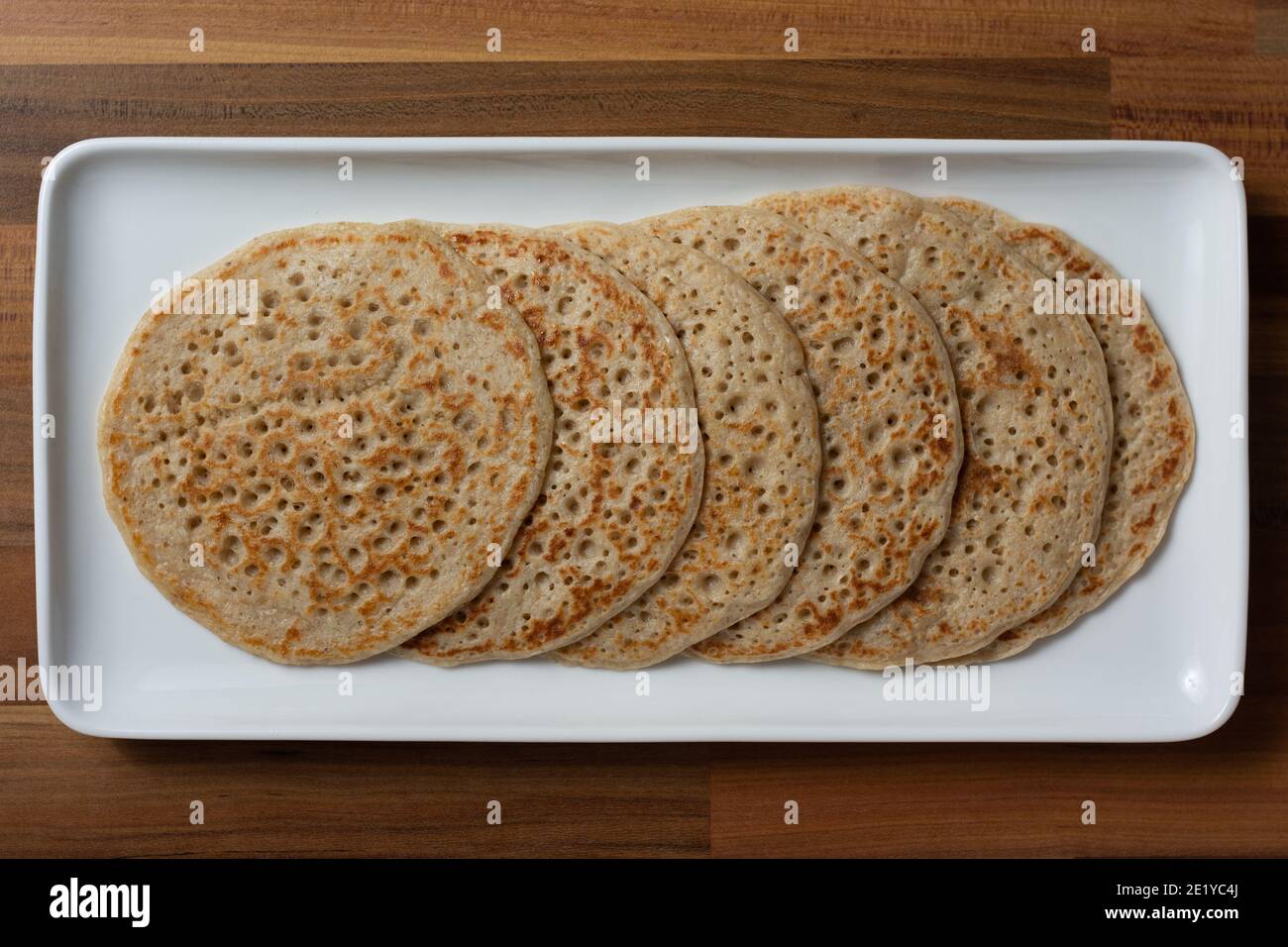 A top down view of Derbyshire oatcakes on a white platter Stock Photo