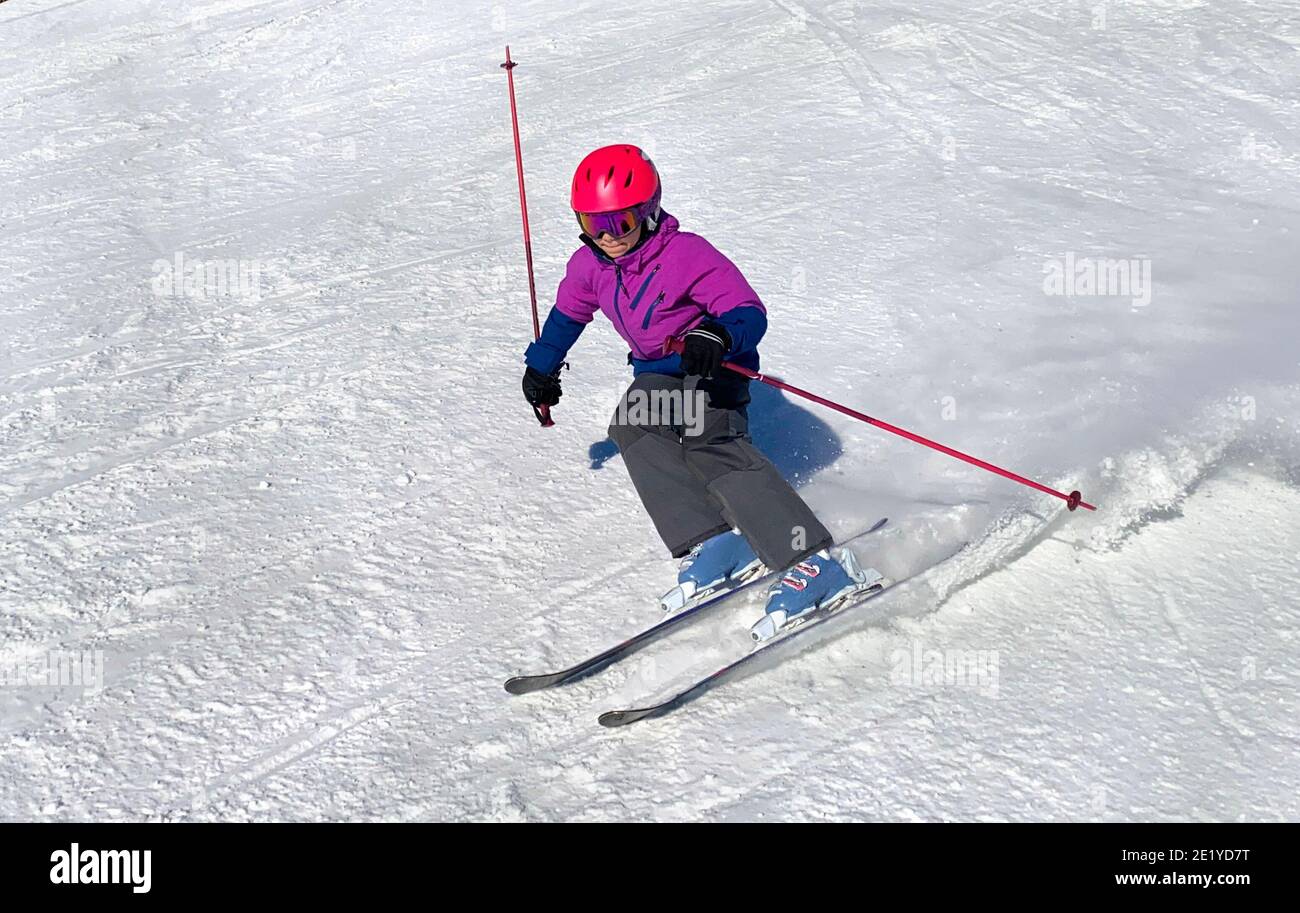 Young girl downhill skiing on an open slope at a ski resort in Quebec, Canada Stock Photo