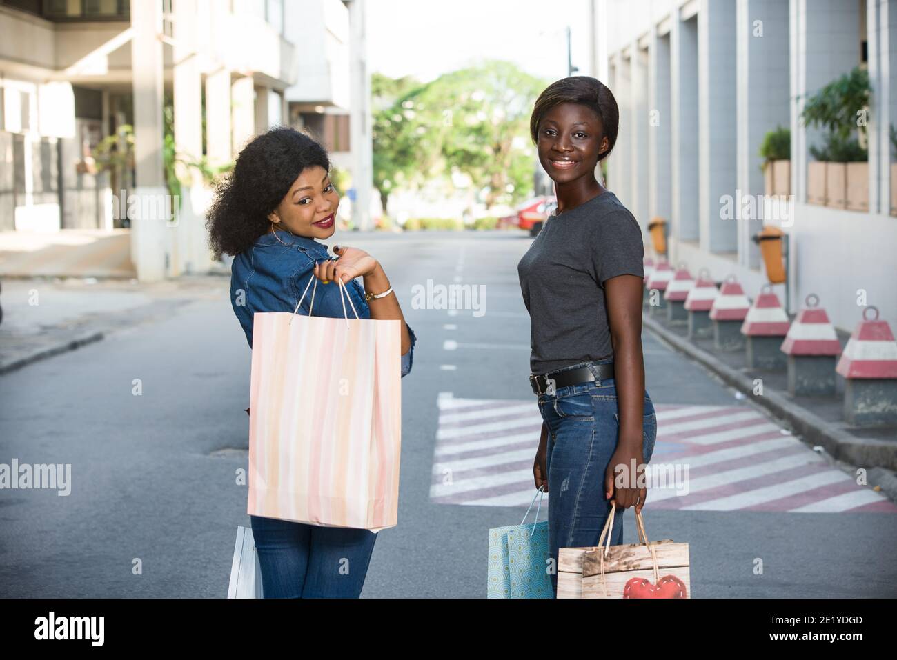 Two girls walking down street hi-res stock photography and images - Alamy
