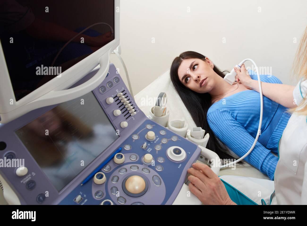 Doctor using ultrasound scanning machine examining female neck Stock ...