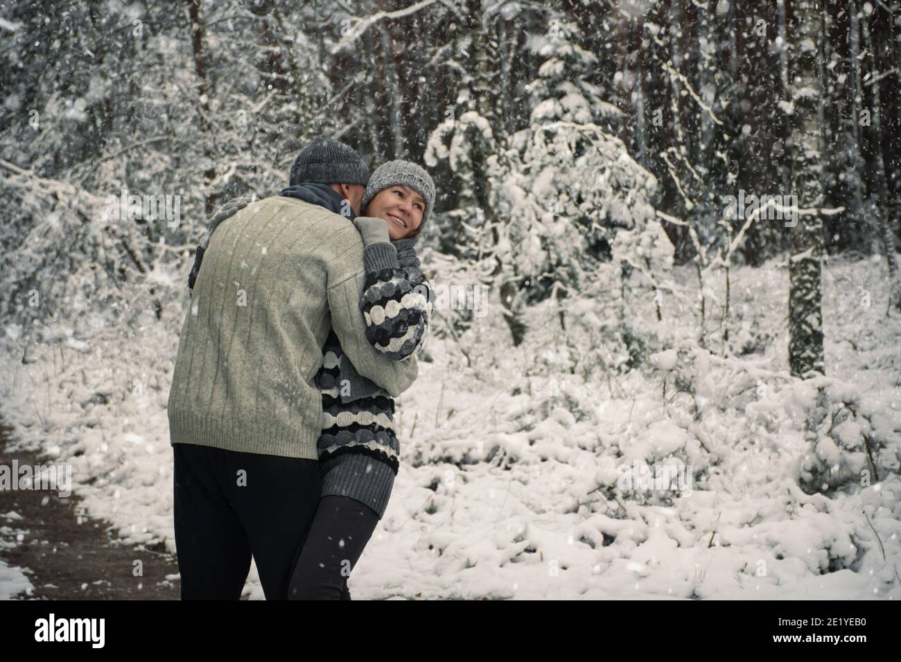 happy couple hugging on a walk in the snowy forest Stock Photo - Alamy