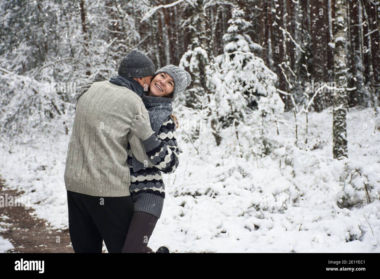 happy couple hugging on a walk in the snowy forest Stock Photo - Alamy