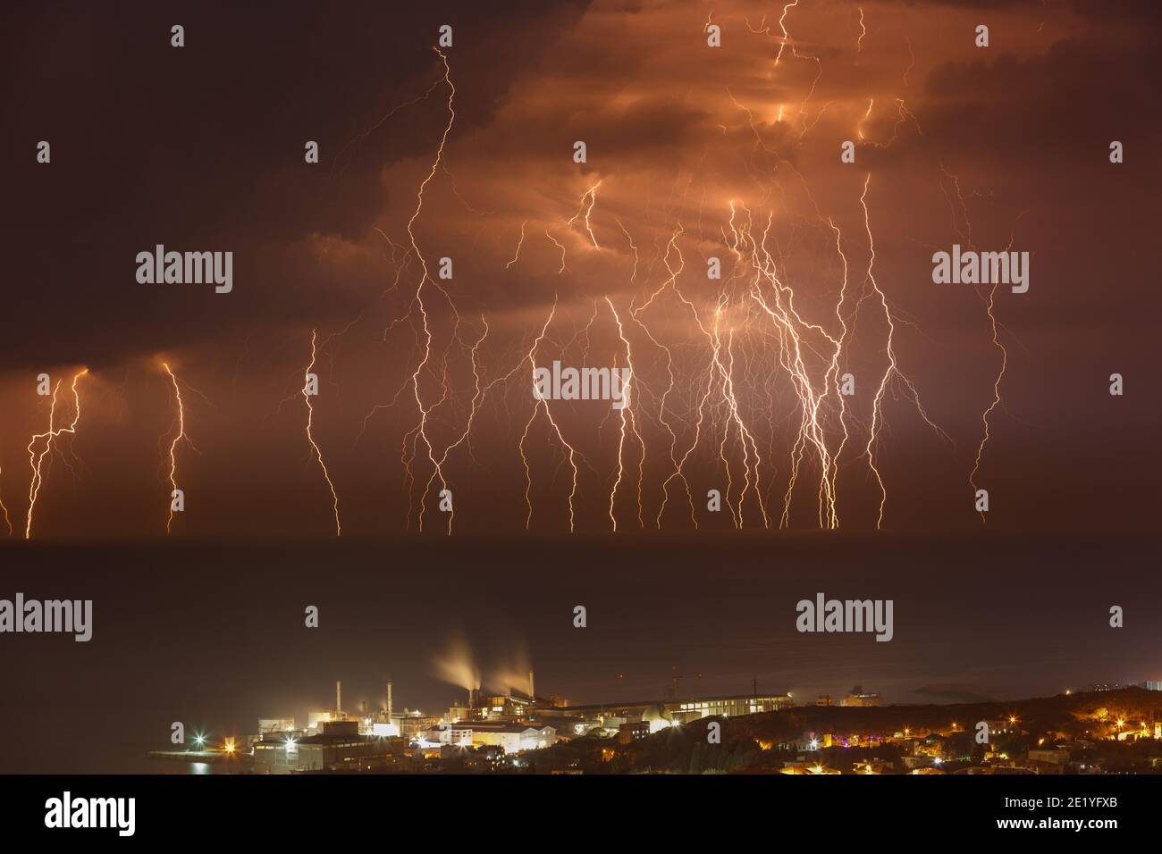 Amazing Landscape of a Beautiful Zippers in Dark Night Sky over the Sea. Coastal City Glowing at Night with Bright Lights. Beauty of Lebanon. Stock Photo