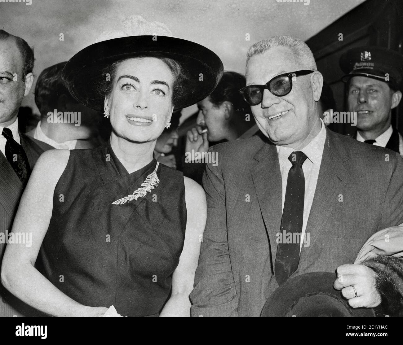 Joan Crawford and her husband, (President of Pepsi Cola) Alfred Steele, on their arrival at Waterloo Station in London, 1956 / File Reference # 34082-102THA Stock Photo
