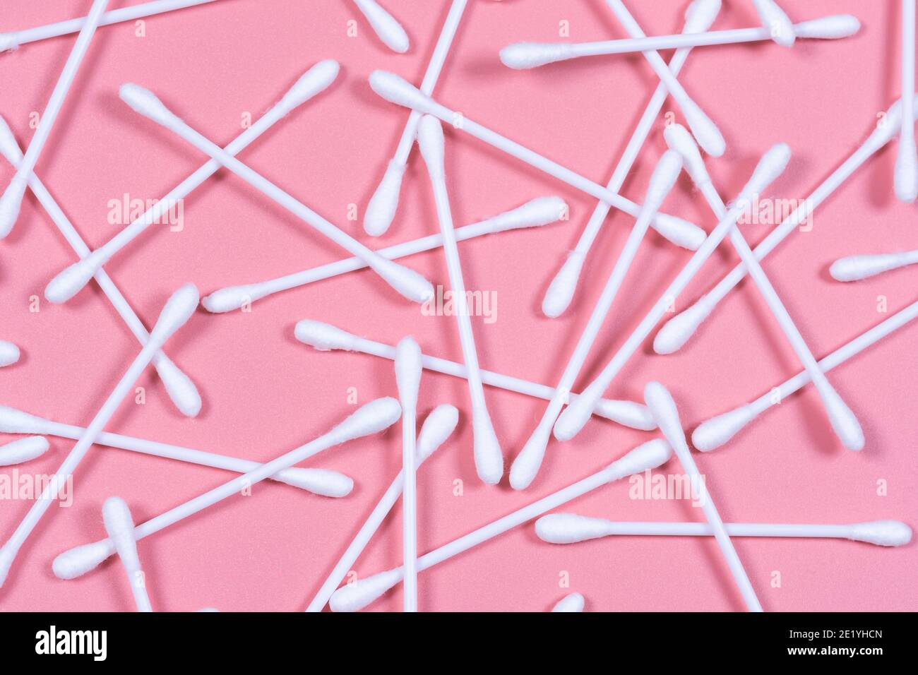 Cotton buds, ear sticks on pink backround. Flat lay, top view. Stock Photo