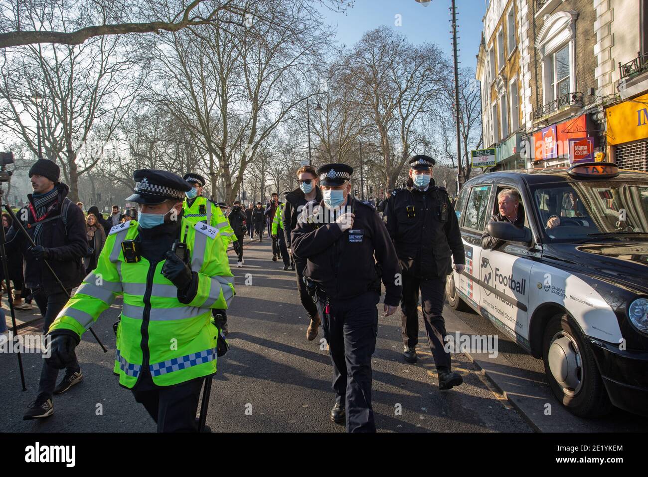 Lockdown protesterand Police on Clapham Common during the anti-lockdown demonstration on January 9, 2021 in London, England.StandUpX are demonstrating. Stock Photo
