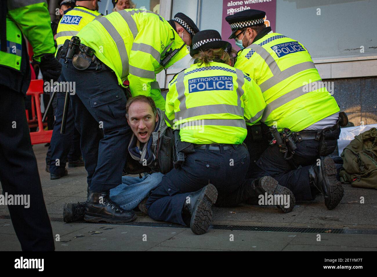 A protester is arrested by Police on Clapham High Street during the anti-lockdown demonstration on January 9, 2021 in London, England.StandUpX are dem Stock Photo