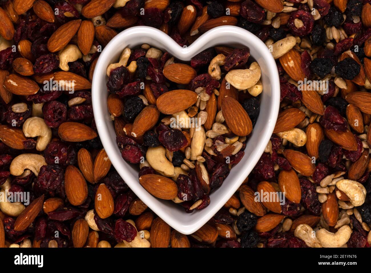 Macro of trail mix with almonds, sunflower seeds, cranberry and raisins