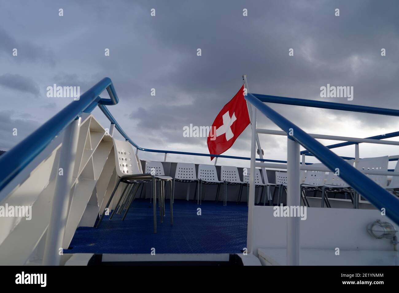 Swiss federal flag blowing in the wind over Lake Zurich on a lake cruise ship. Stock Photo