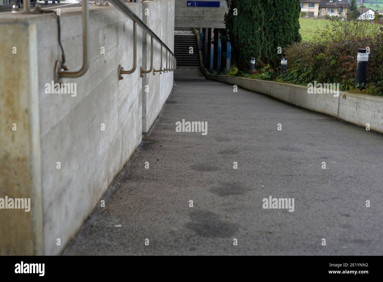 Subway crossing or underpass with inclined plane in train station village Urdorf, Switzerland. Stock Photo