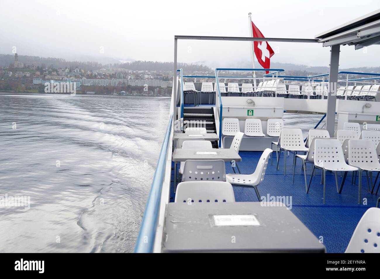 Swiss federal flag blowing in the wind over Lake Zurich on a lake tourist ship. Stock Photo