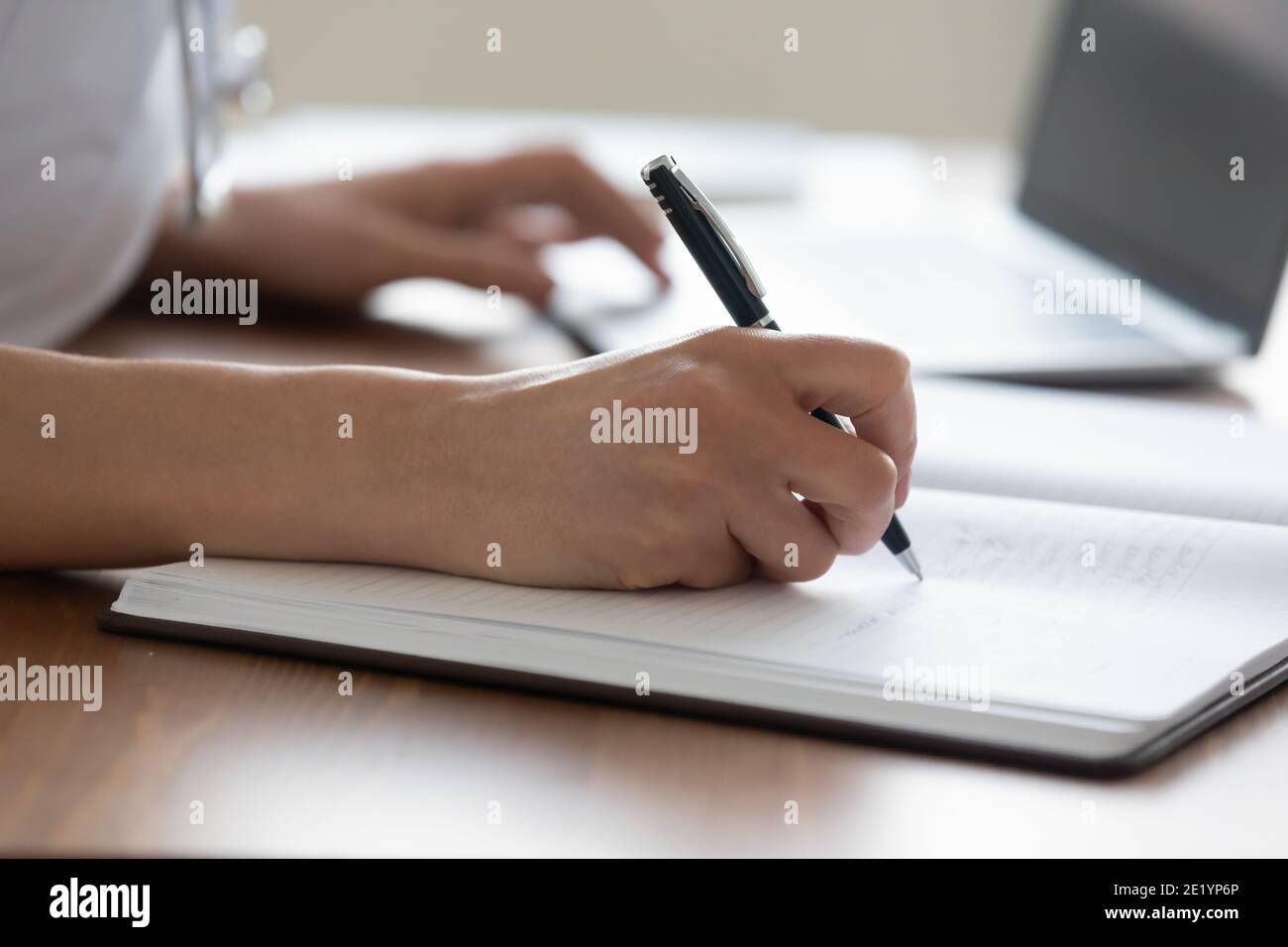 Close up young female medical worker handwriting notes. Stock Photo