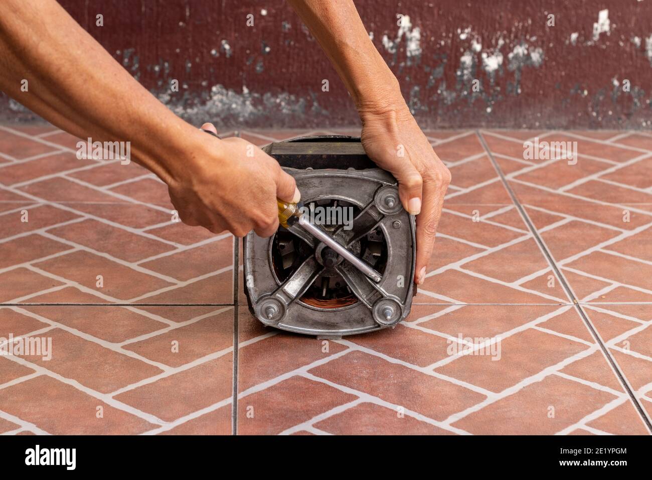 washing machine motor repair , mechanic working on electric engine