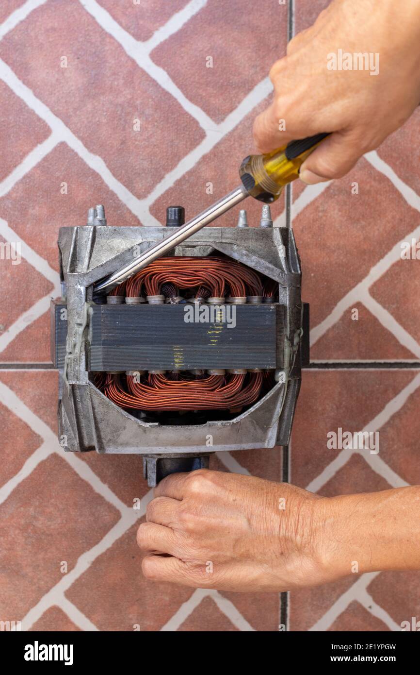washing machine motor repair , mechanic working on electric engine