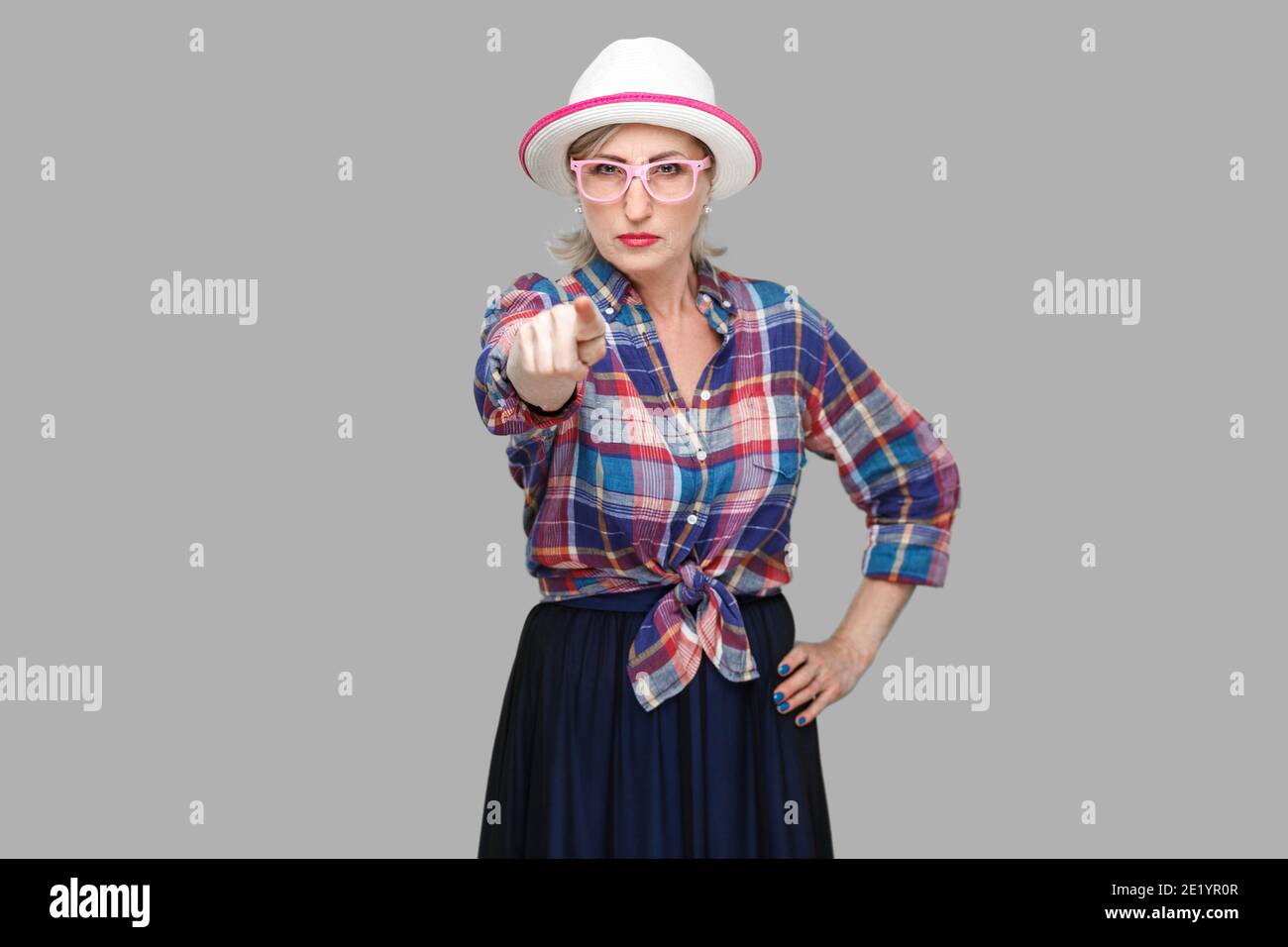 Hey you. Portrait of serious bossy modern stylish mature woman in casual style with hat and eyeglasses standing, pointing and looking at camera. indoo Stock Photo