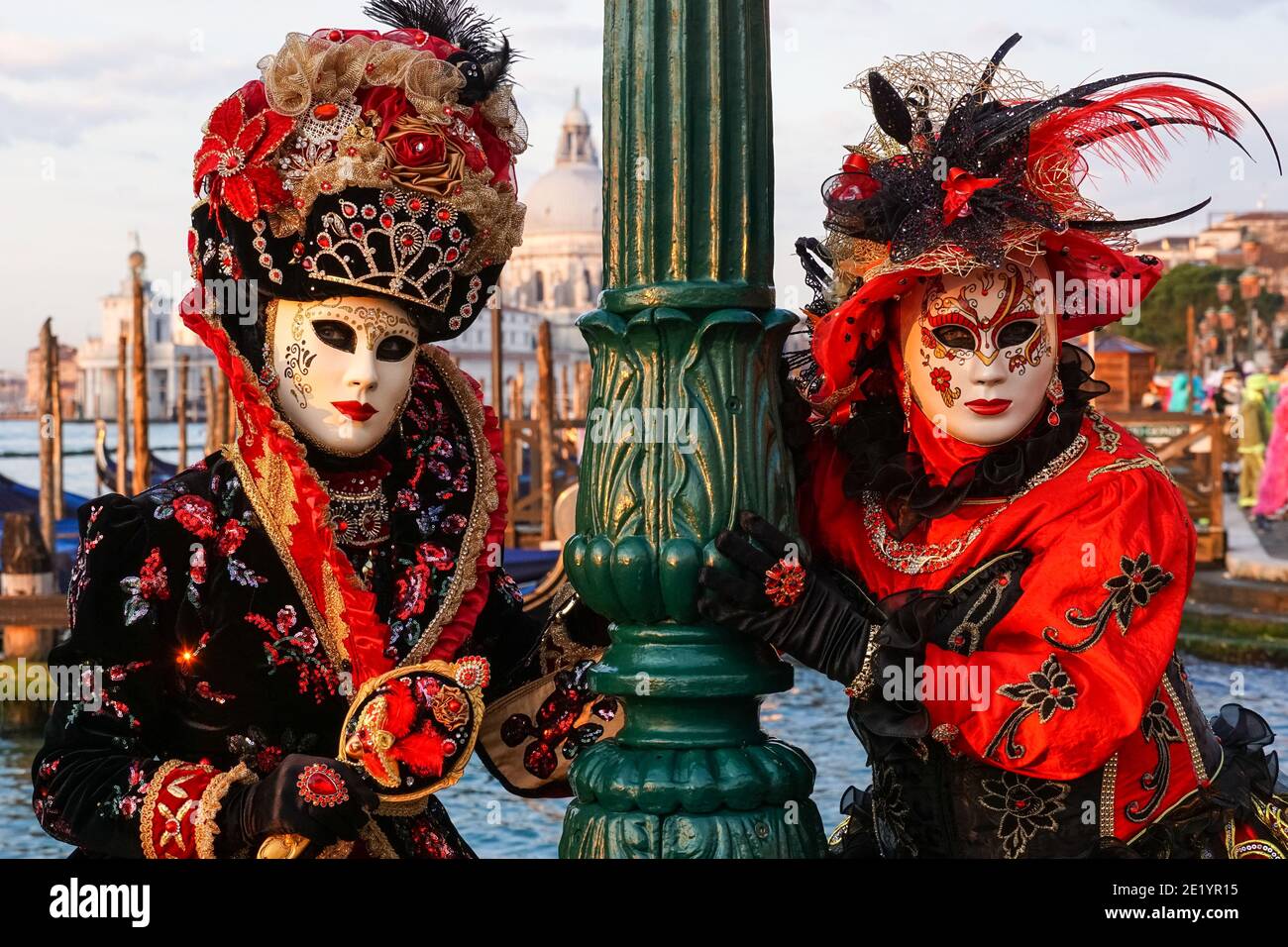 Two women dressed in traditional decorated costumes and painted masks during the Venice Carnival in Venice, Italy Stock Photo