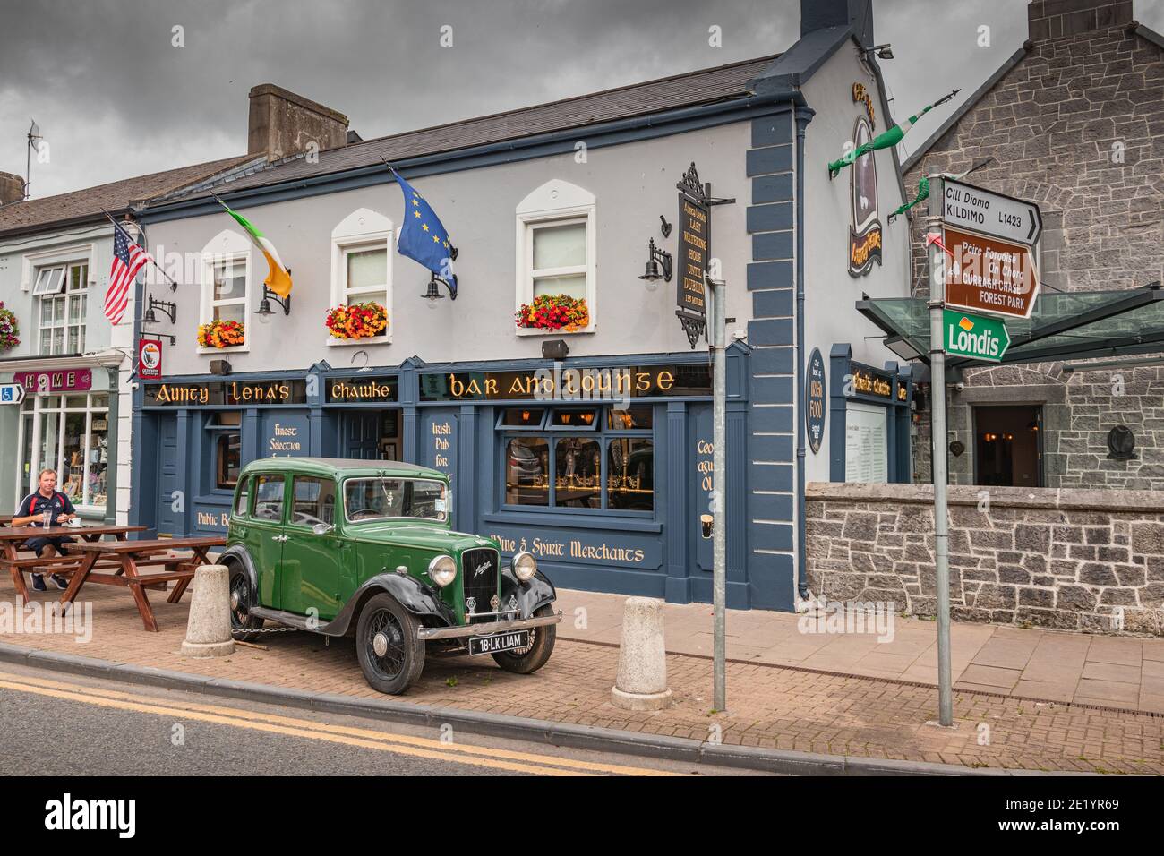 Adare, Limerick, Ireland 07.21.2019 View of a typical Irish pub with the blue facade and vintage car in the town of Adare. Europe Stock Photo