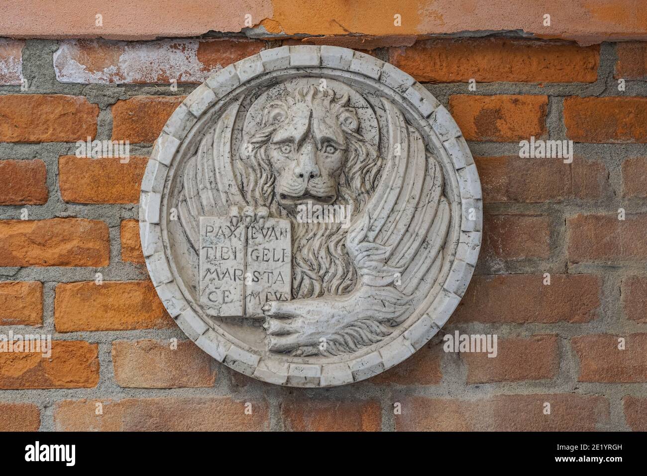 Lion of Saint Mark relief on the wall of a building in Venice, Italy Stock Photo