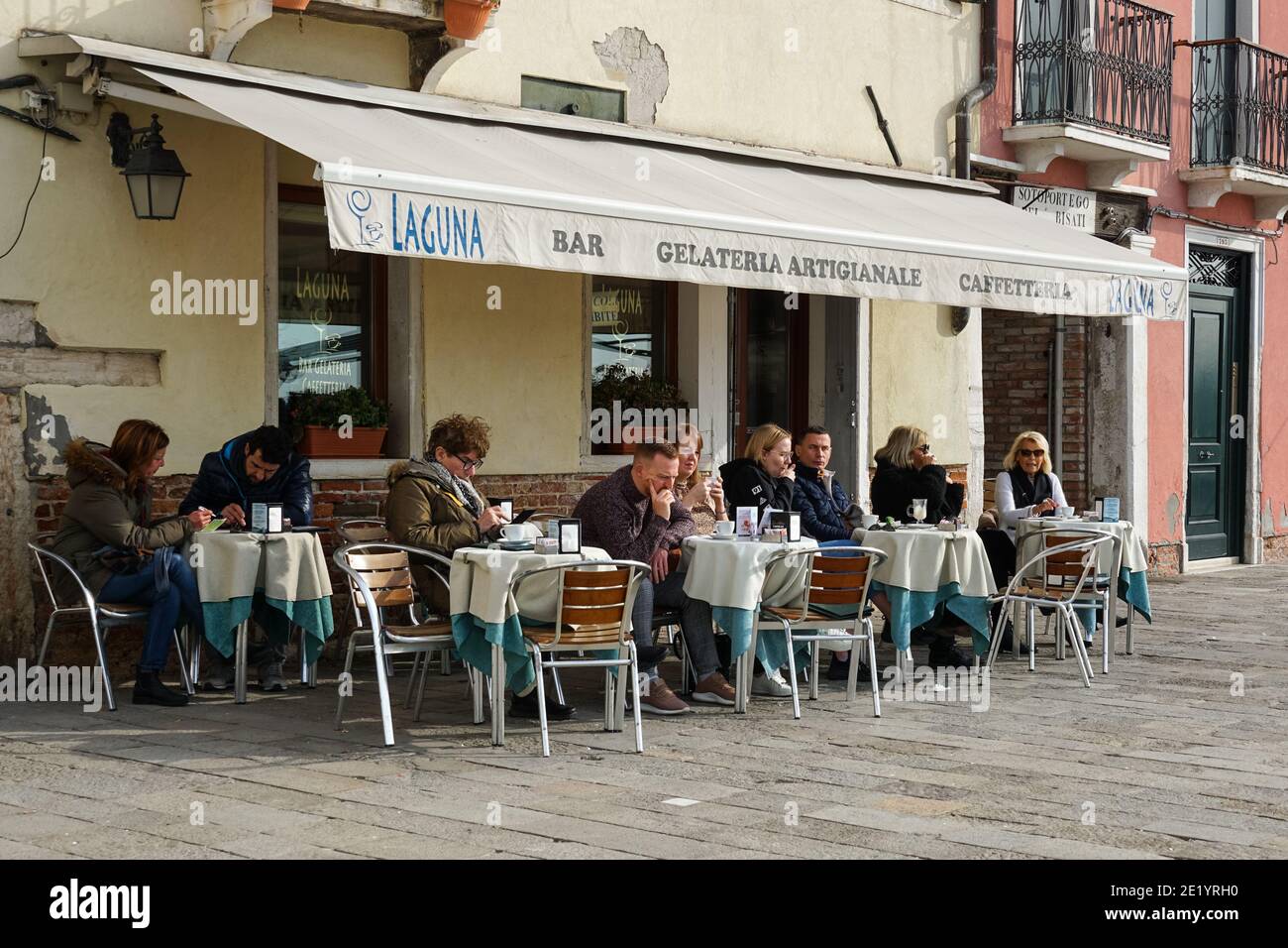 People sitting outside cafe in the sestiere of Dorsoduro, Venice, Italy Stock Photo