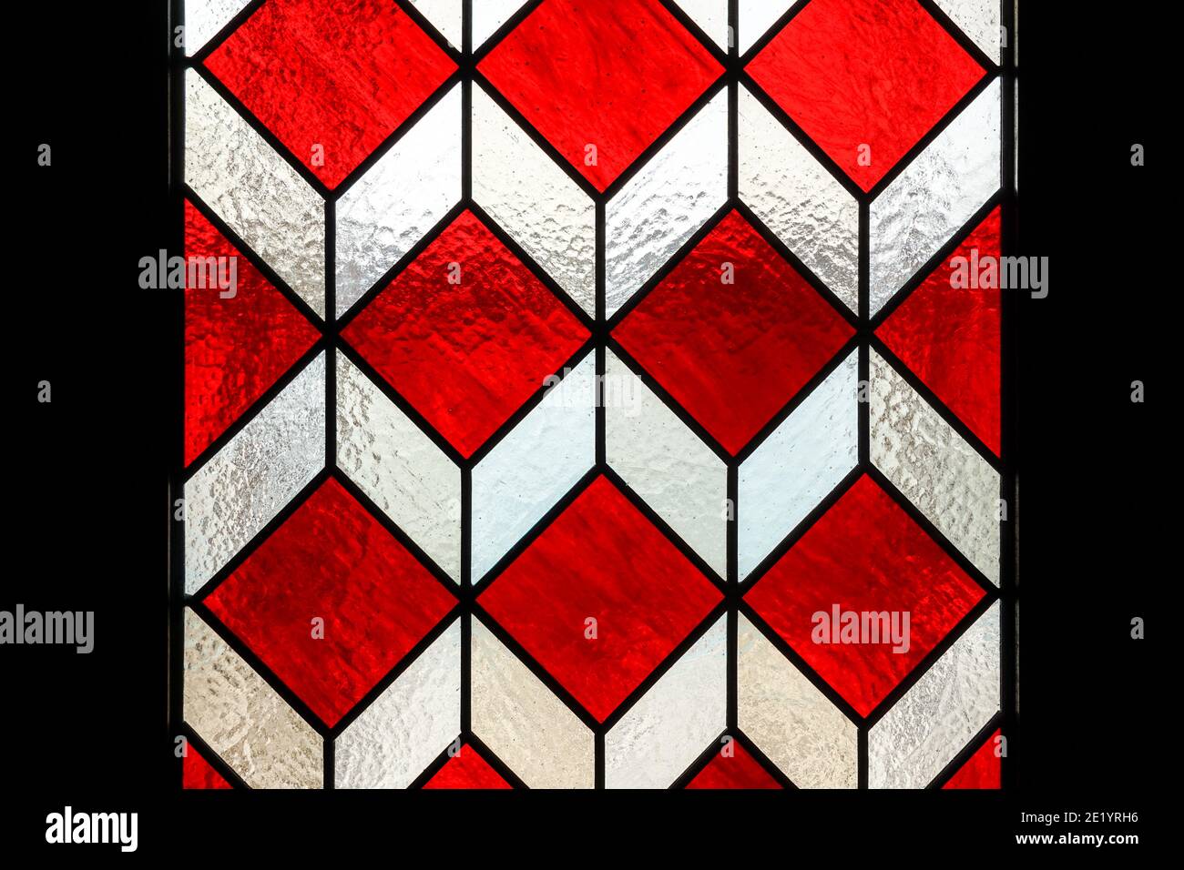 Door with red geometric stained glass elements Stock Photo