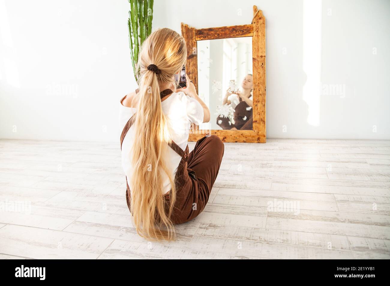 Young female taking selfie in front of mirror Stock Photo