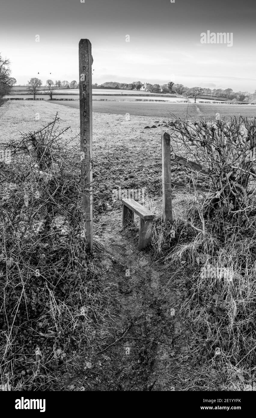 Wooden post showing a public footpath over a field towards Ault Hucknall, Derbyshire, Stock Photo