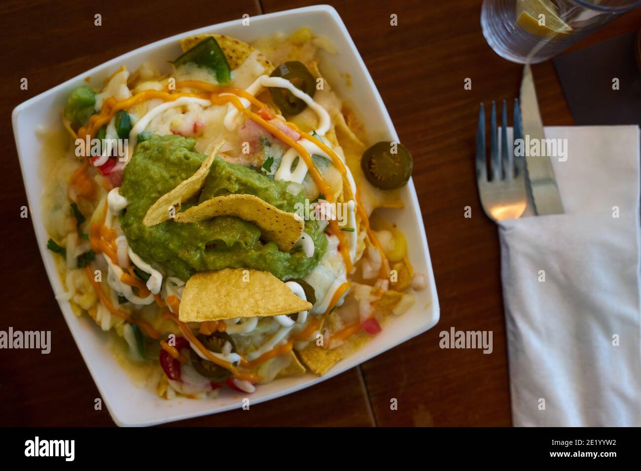 Mexican dish, nachos with cheese and vegetables, selective focus Stock Photo