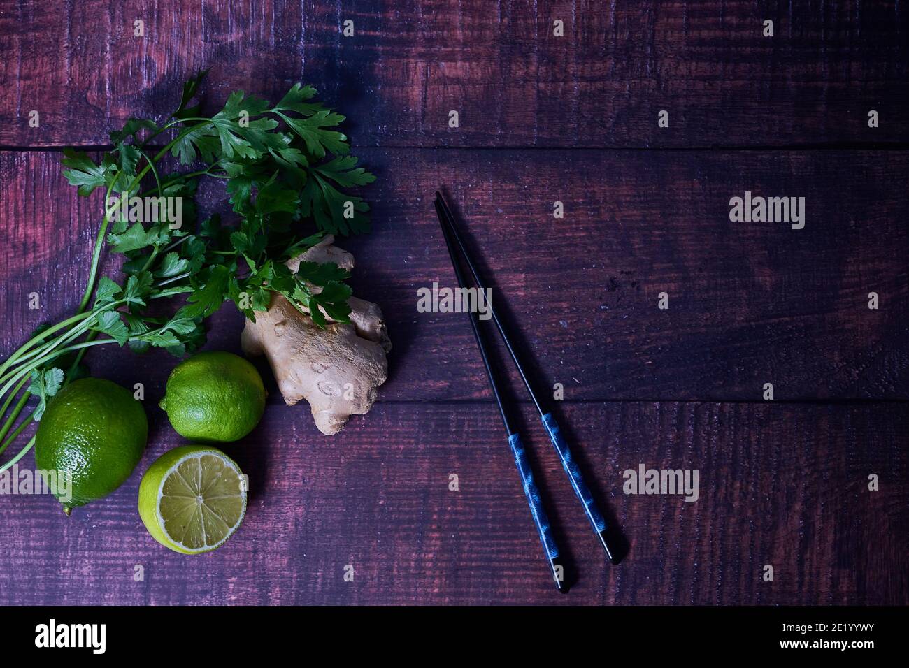 Fresh ingredients on wooden board. lime, coriander, parsley. Stock Photo
