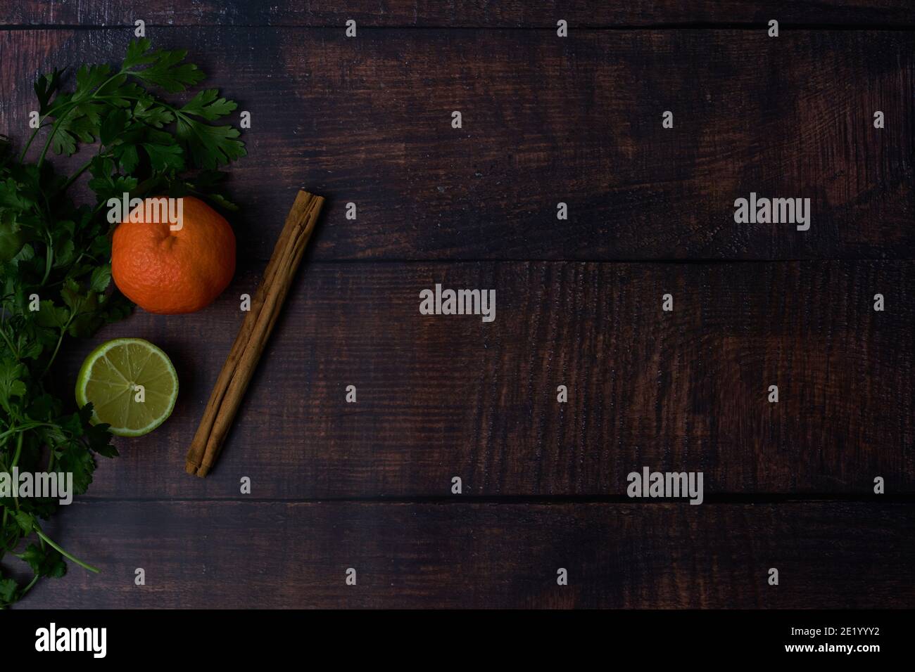 ingredients on wooden board, tangerine cinnamon parsley Stock Photo