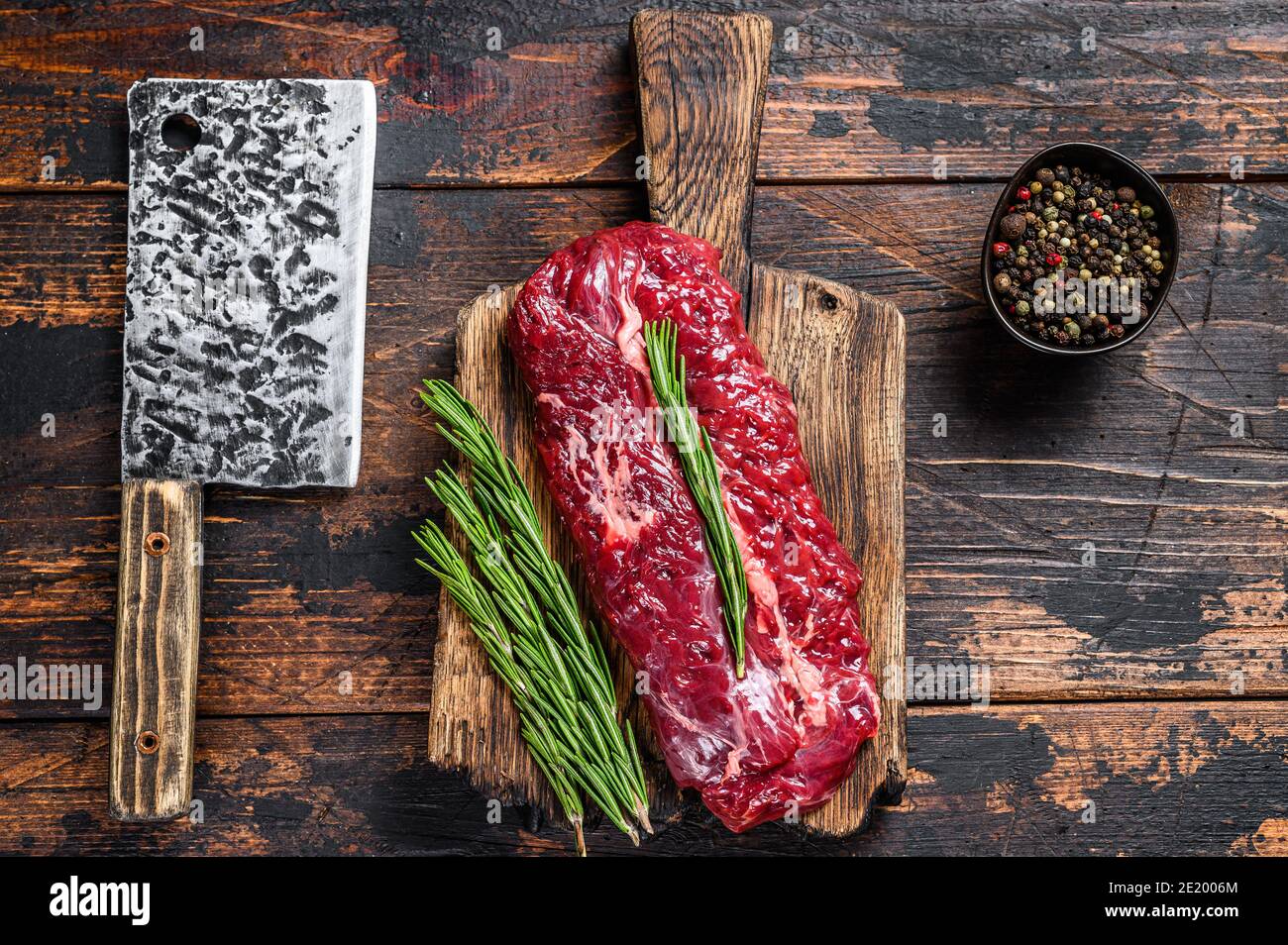 Butchers choice raw steak Onglet Hanging Tender beef meat on a cutting board. Dark wooden background. Top view Stock Photo